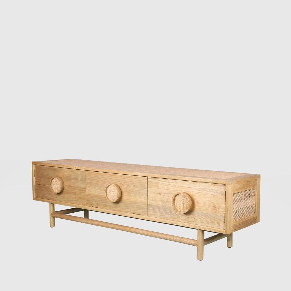 Wooden console table with round door handles on a light gray background