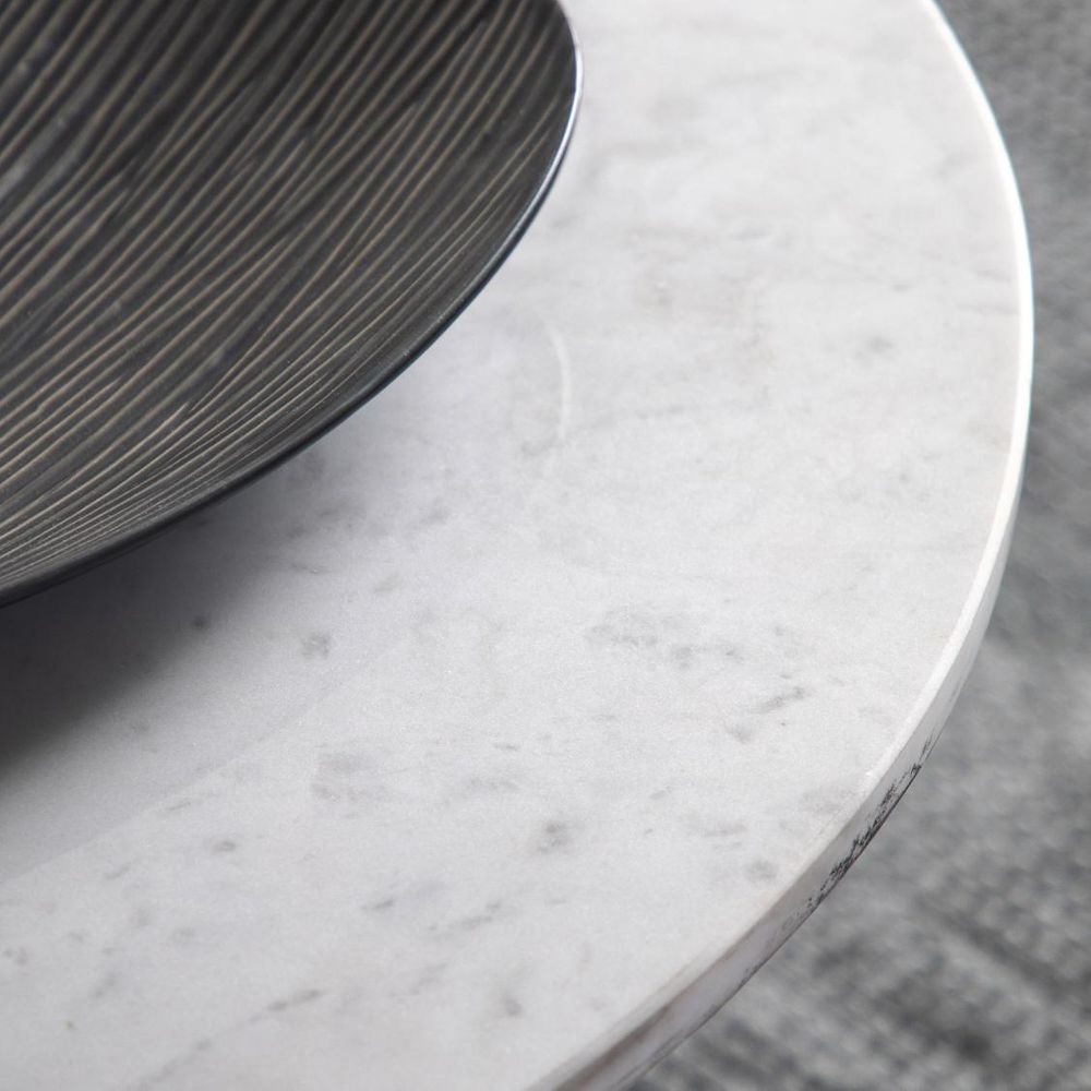 Round marble table with a textured surface