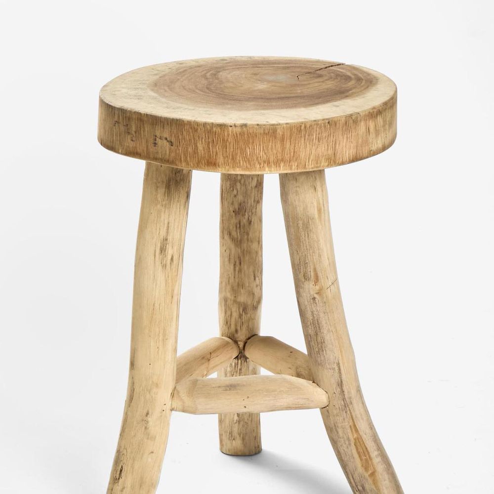 Wooden stool with a round top on a white background